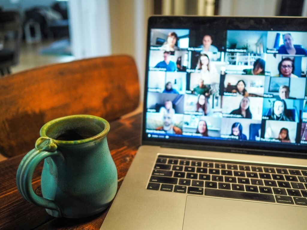 A beverage, and a screen connected to many collaborators.